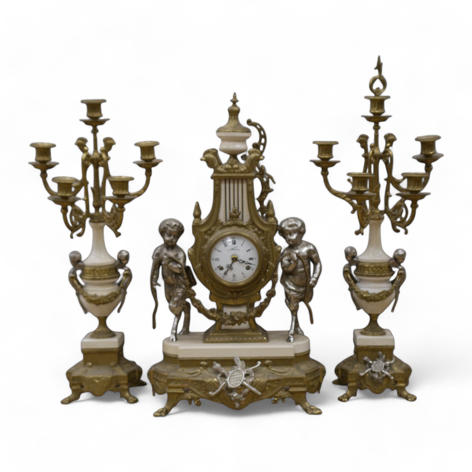 An ornate mixed metal putti clock and five light garniture, garnitures 59.5cm high. Condition - fair to good